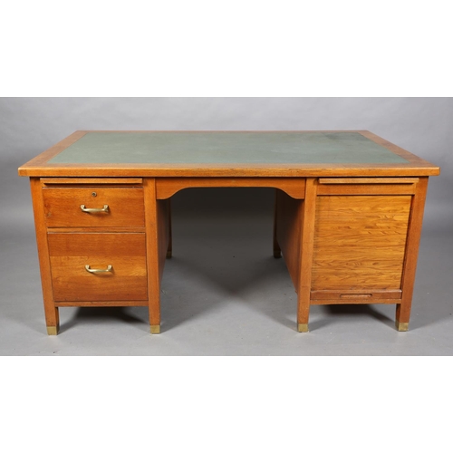 162 - A mid 20th century oak desk, having a green rexine incised surface, slide, drawer and filling drawer... 