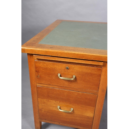 162 - A mid 20th century oak desk, having a green rexine incised surface, slide, drawer and filling drawer... 