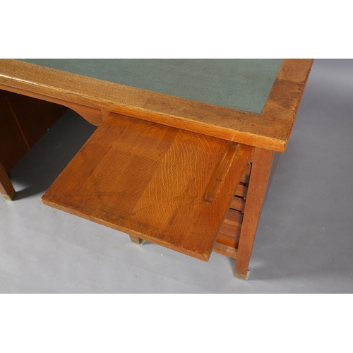 162 - A mid 20th century oak desk, having a green rexine incised surface, slide, drawer and filling drawer... 