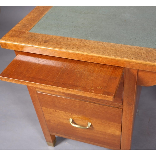 162 - A mid 20th century oak desk, having a green rexine incised surface, slide, drawer and filling drawer... 