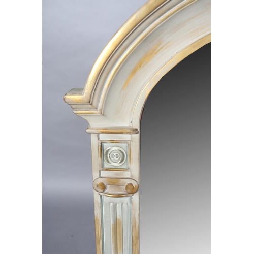 147 - A grey and rubbed gilt wall mirror of arched outline, the bevelled glass flanked by Ionic columns, 1... 