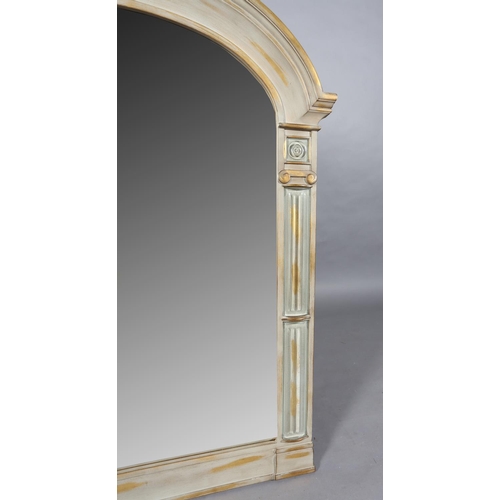 147 - A grey and rubbed gilt wall mirror of arched outline, the bevelled glass flanked by Ionic columns, 1... 