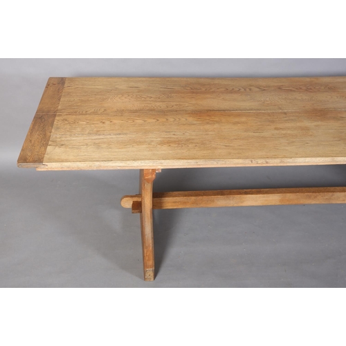 152 - An oak refectory table, planked top on waisted standards joined by a low and a high stretcher, 262cm... 