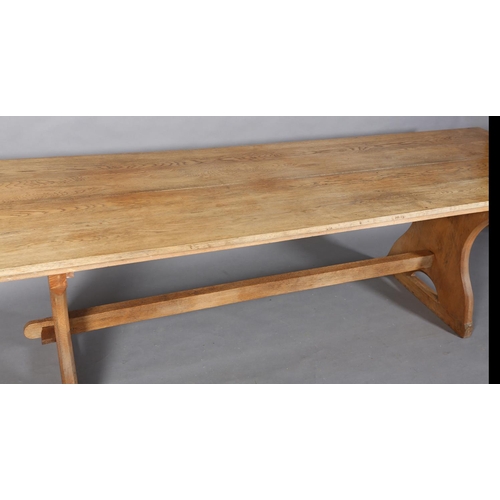 152 - An oak refectory table, planked top on waisted standards joined by a low and a high stretcher, 262cm... 