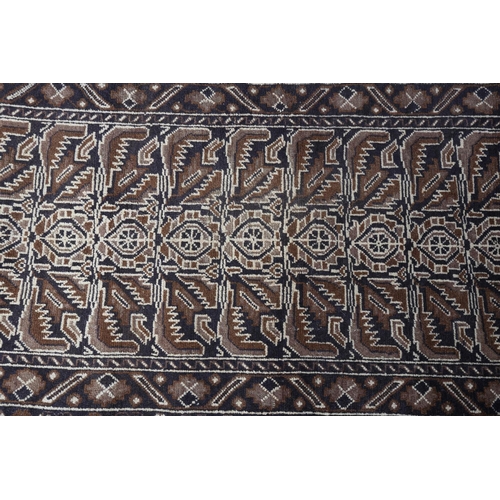 156 - A Caucasian rug, the camel ground with alternating panels of stylised plant forms in shades of brown... 