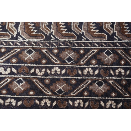 156 - A Caucasian rug, the camel ground with alternating panels of stylised plant forms in shades of brown... 