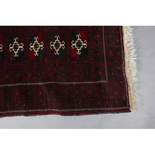 105 - A Bokhara rug of deep aubergine, ivory and blue, the field filled with three rows of ten small medal... 