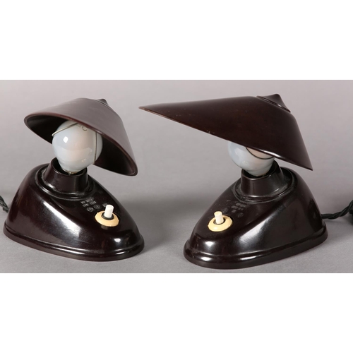 140 - A pair of Bauhaus black Bakelite lamps, Czechoslovakia 1930s, the oval shade with wire clip to attac... 