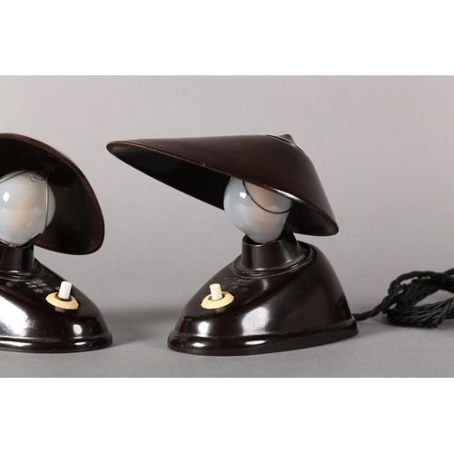 140 - A pair of Bauhaus black Bakelite lamps, Czechoslovakia 1930s, the oval shade with wire clip to attac... 