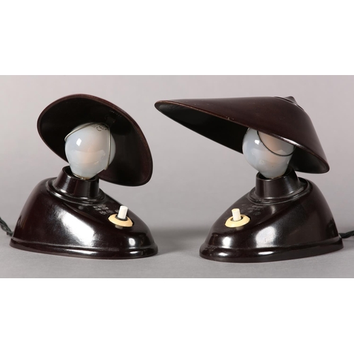 140 - A pair of Bauhaus black Bakelite lamps, Czechoslovakia 1930s, the oval shade with wire clip to attac... 