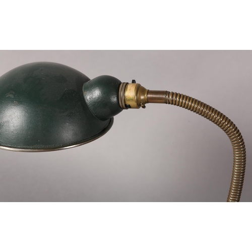 42 - A 1930s desk lamp, with green enamelled cup-shape shade, on adjustable goose neck column on domed ci... 