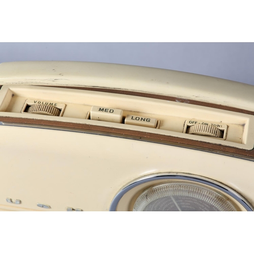 44 - A Bush wireless in cream plastic and brown rexine base with swing handle, 33cm wide