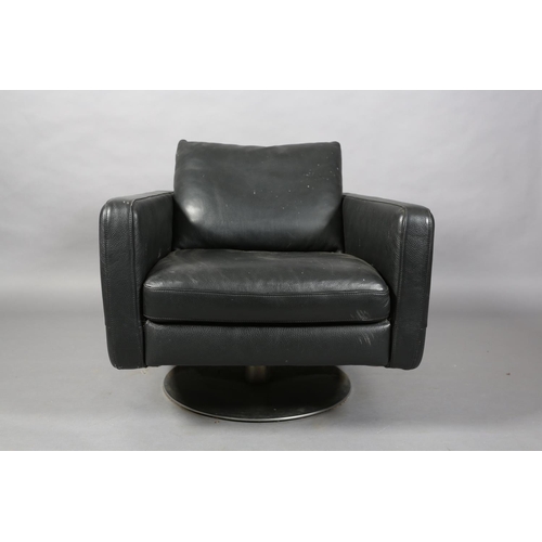 56 - A Natuzzi black leather swivel armchair of square form on a circular chrome base