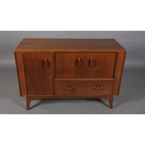 66 - An early G Plan Brandon oak sideboard, having a two door cupboard above a deep drawer flanked by a f... 