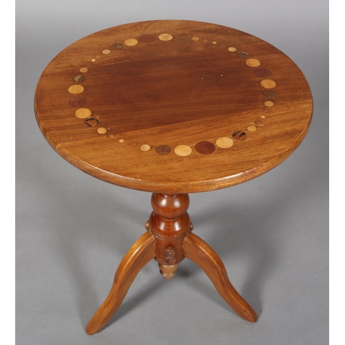 121 - A walnut tripod table, the circular top inlaid in exotic woods with a ring of circles of various siz... 