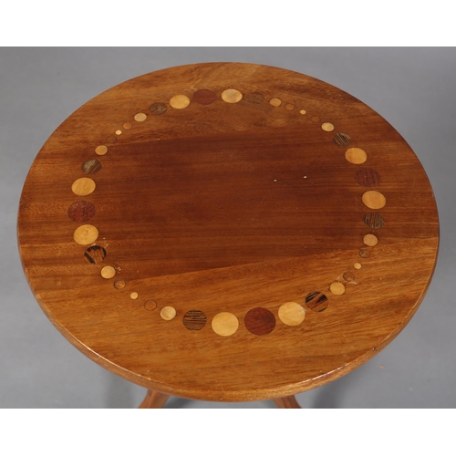 121 - A walnut tripod table, the circular top inlaid in exotic woods with a ring of circles of various siz... 