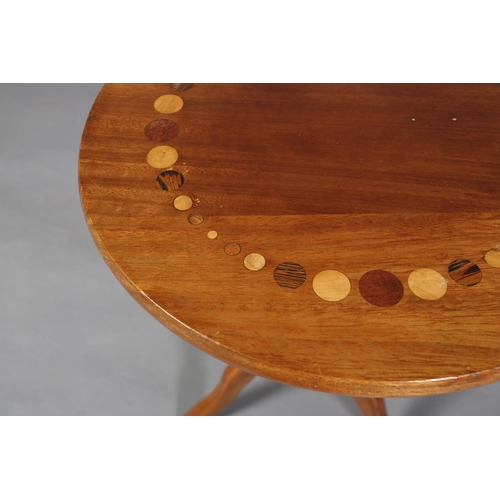 121 - A walnut tripod table, the circular top inlaid in exotic woods with a ring of circles of various siz... 