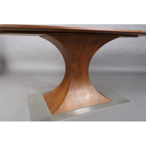 36 - A walnut and steel oval pedestal dining or centre table, the pedestal of waisted rectangular form on... 