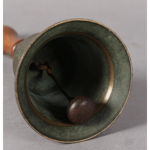 85 - An early 20th century handbell with turned wood handle, 26.5cm high together with a vintage cowboy's... 