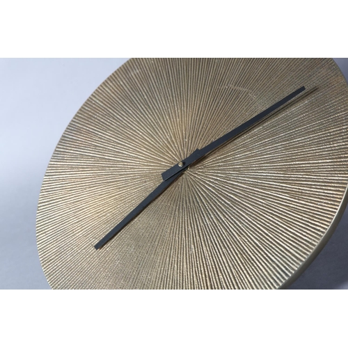 23 - A gilt metal clock of circular sunburst design with black baton hands, battery movement, 39cm diamet... 