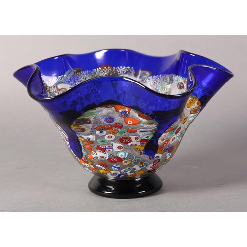 17 - A Murano millefiori murrina glass vase, the folded rim with border and drips in blue glass and on bl... 