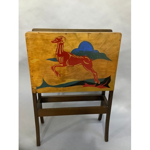 39 - An Art Deco magazine rack, the plywood sides each painted with a leaping antelope against a landscap... 