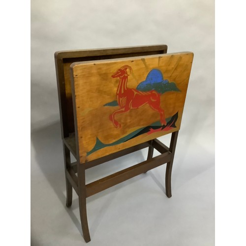 39 - An Art Deco magazine rack, the plywood sides each painted with a leaping antelope against a landscap... 