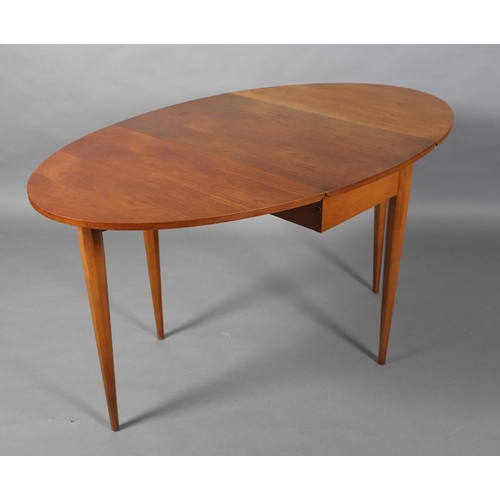 309 - A small teak oval drop leaf dining table, on octagonal and tapered legs, 145cm x 83.5cm