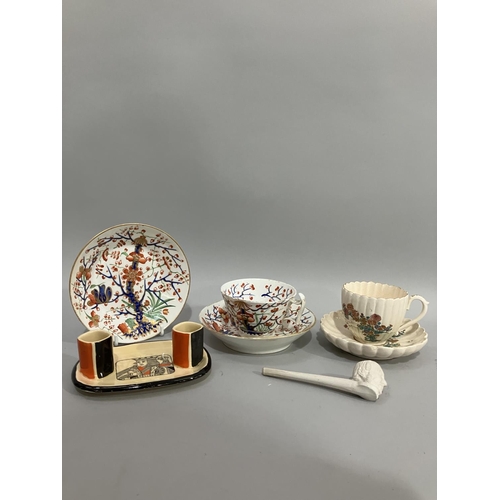 12 - An early 19th century Derby porcelain teacup and two saucers painted with rocks issuing blossom with... 