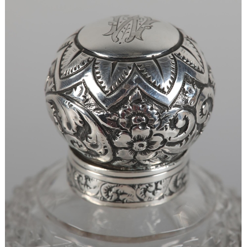 22 - A VICTORIAN SILVER LIDDED AND CUT GLASS SCENT BOTTLE of ovoid form, Birmingham 1897 for Colen Hewer ... 