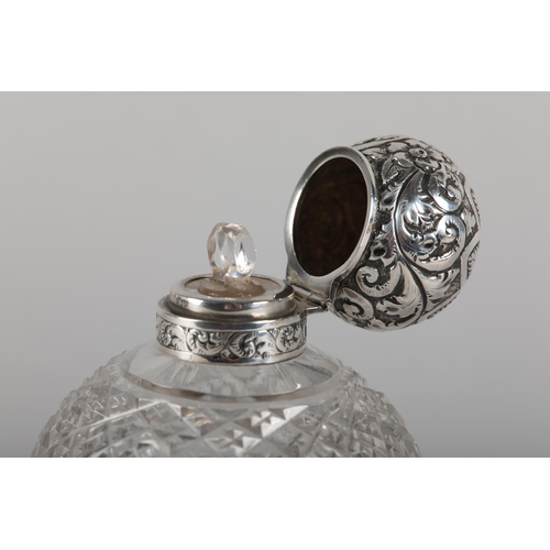 22 - A VICTORIAN SILVER LIDDED AND CUT GLASS SCENT BOTTLE of ovoid form, Birmingham 1897 for Colen Hewer ... 