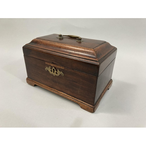 14 - A George III mahogany sarcophagus tea caddy having a brass swing handle to the lid, a pierced escutc... 