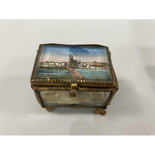 26 - Two French gilt metal an glass jewellery caskets of rectangular form each inset with colour view of ... 