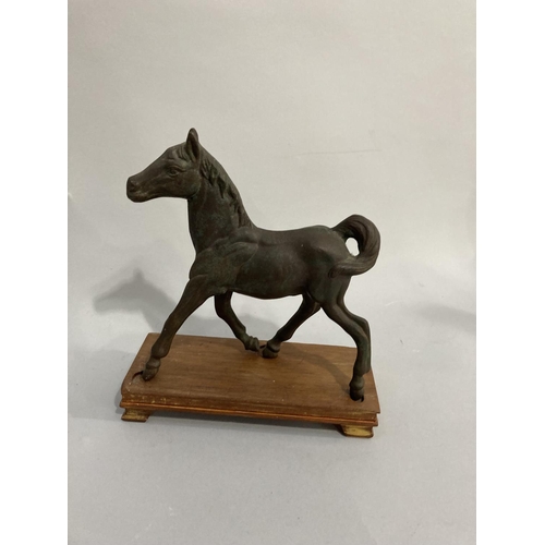 34 - A bronze effect model of the flying horse of Kang-Hsi on wooded stand together with another, approx.... 