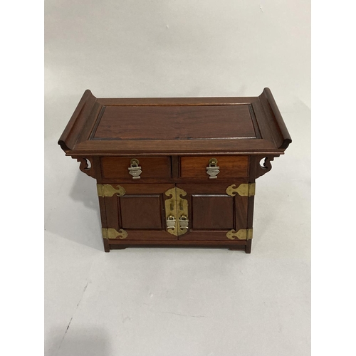 35 - A modern, Chinese hardwood, jewel casket fitted with two small drawers, two doors internally fitted ... 