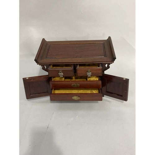 35 - A modern, Chinese hardwood, jewel casket fitted with two small drawers, two doors internally fitted ... 