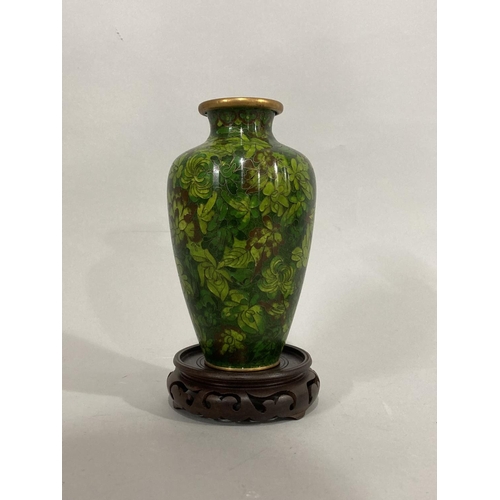 39 - A Chinese cloisonné vase of leaf decoration in green and brown, tapered form, 18cm high and with a s... 