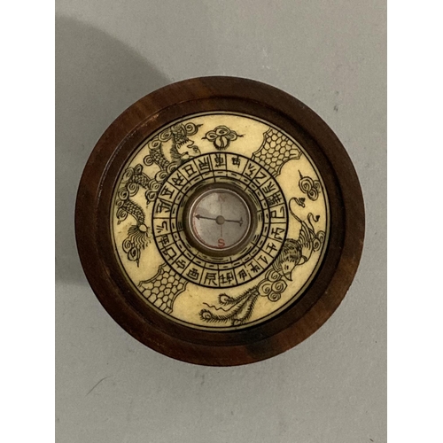 40 - A Chinese hardwood and resin inset compass, the domed cover inset with reserves of animals of the Ch... 