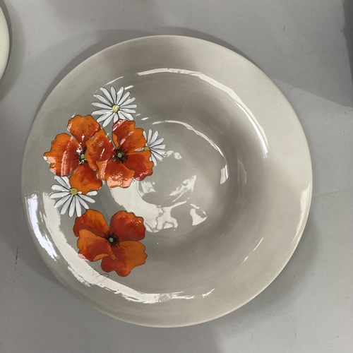 42 - An Italian pottery platter and bowl, each painted with poppies  and margarites against a pale grey g... 