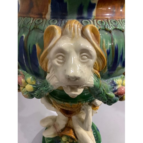 2 - A Victorian style Majolica glazed jardiniere the circular bowl moulded in relief with lion masks and... 