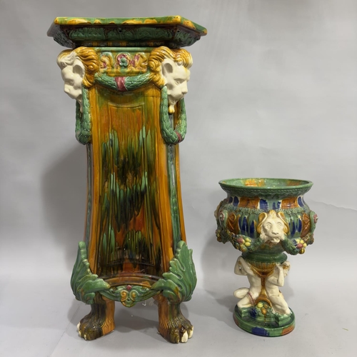 2 - A Victorian style Majolica glazed jardiniere the circular bowl moulded in relief with lion masks and... 