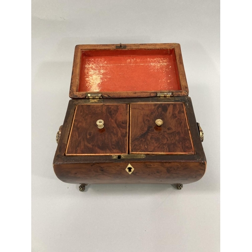 11 - An early 19th century burr walnut sarcophagus shaped tea caddy with boxwood stringing, semi domed li... 