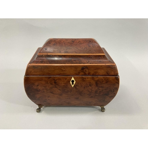 11 - An early 19th century burr walnut sarcophagus shaped tea caddy with boxwood stringing, semi domed li... 