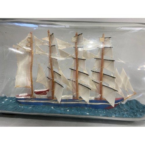 33 - A large ship in a bottle, 50cm high, the bottle marked to the base: William Teachers and Sons, Glasg... 