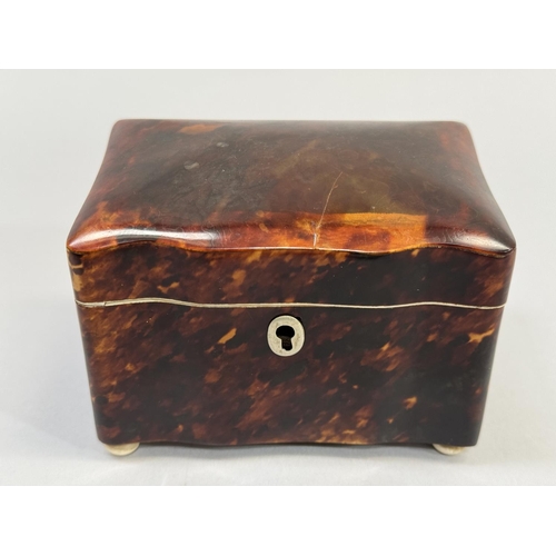 70 - A REGENCY TORTOISESHELL TEA CADDY, rectangular serpentine outline, ivory stringing and compressed fe... 