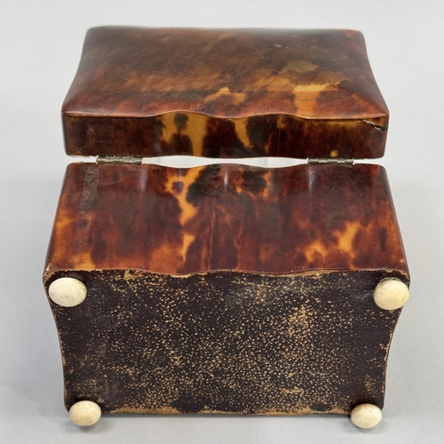 70 - A REGENCY TORTOISESHELL TEA CADDY, rectangular serpentine outline, ivory stringing and compressed fe... 