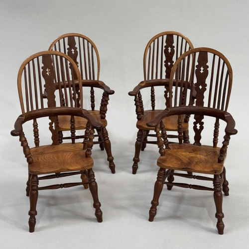 77 - A SET OF FOUR MINIATURE HIGH BACK WINDSOR ARMCHAIRS, in elm and specimen woods, 14.5cm high