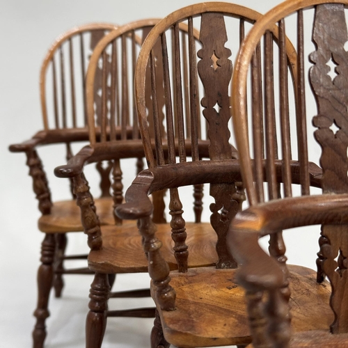 77 - A SET OF FOUR MINIATURE HIGH BACK WINDSOR ARMCHAIRS, in elm and specimen woods, 14.5cm high