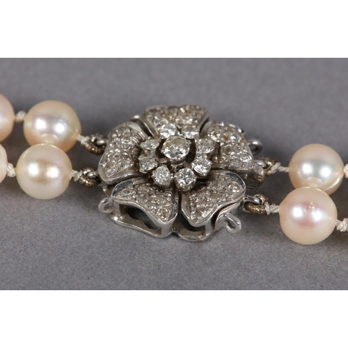 432 - A CULTURED PEARL AND DIAMOND NECKLACES, c1950, the two rows of 7mm pearls fastened with a four row s... 