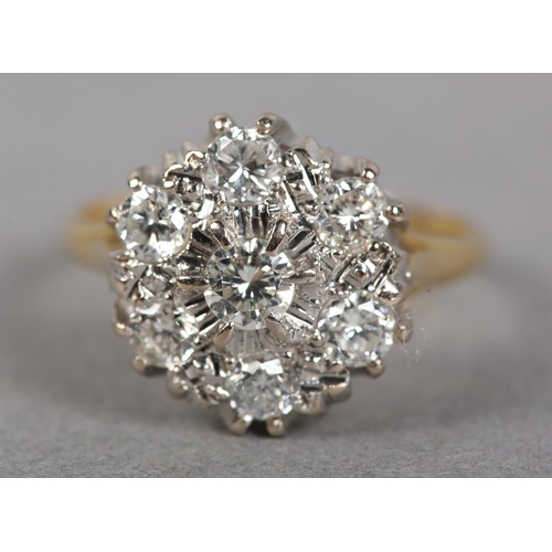 436 - A DIAMOND CLUSTER RING in 18ct yellow and white gold, the brilliant cut stones claw and grain set wi... 